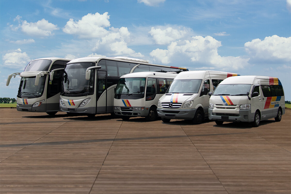 The Season Bus fleet lined up under a blue sky